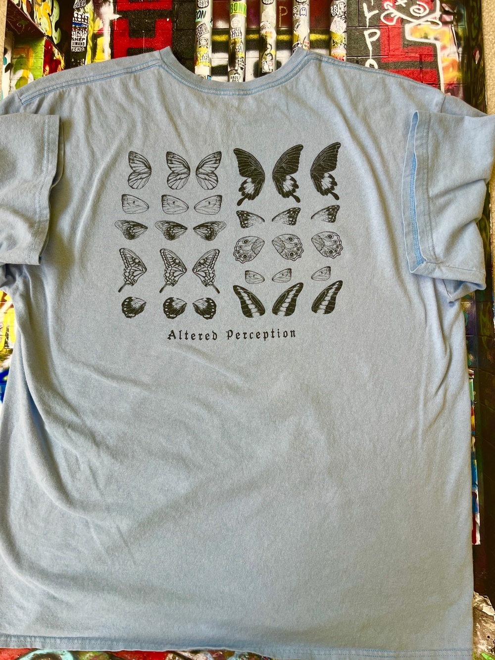 Empyre Light Blue Short Sleeve Tee with Black Butterfly Graphic